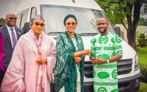 L-R , Wife of the Vice President of Nigeria and National Vice Chairmen of Renewed Hope Initiative, Nana Shettima, First Lady of Nigeria and National Chairman of Renewed Hope Initiative, Oluremi Tinubu, and National Chairman of YOWICAN Michael Belosochukwu and at the presentation of 7 Hybrid 14-seater busues to the group by the RHI at the State House, Abuja on Thursday 29th May, 2025