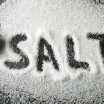 word-salt-made-sea-salt-spoon-black-smokey-background-scaled-1-780×470