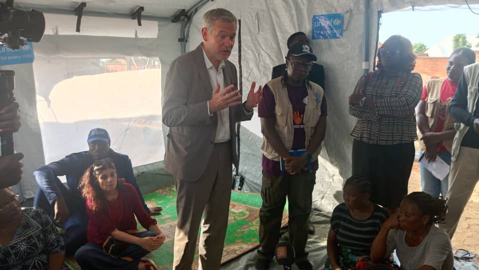 The European Union Ambassador to Nigeria, Gautier Mignot, and other officials addressing and listening to victims during a chat at IDP camp in Makurdi