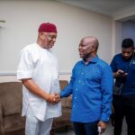Senator Orji Uzor Kalu (L) shakes hands with Abia Governor Alex Otti (R)