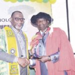 Abdul (left) presenting plaque to Olufolabo