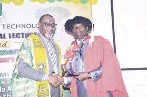 Abdul (left) presenting plaque to Olufolabo