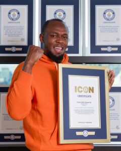 Usain Bolt with Guinness World Records Icon certificate