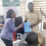 Former DG, Professor Olawale Moronkola ably represented by Omonode .T. Christyne, Head of Department of Coaching and Training (L) handing over to the new DG, Comrade Philip Shaibu