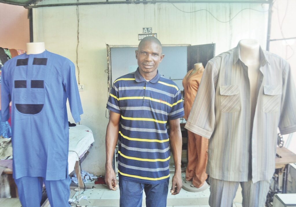 Kadiri at his fashion design shop in Mararaba, Nasarawa State