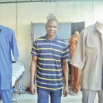 Kadiri at his fashion design shop in Mararaba, Nasarawa State