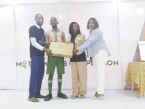 L-R- Dr Olukayode, Debbie and Toyin presenting a laptop to Oluwafareanmi