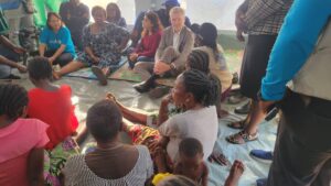 The European Union Ambassador to Nigeria, Gautier Mignot, and other officials addressing and listening to victims during a chat at IDP camp in Makurdi