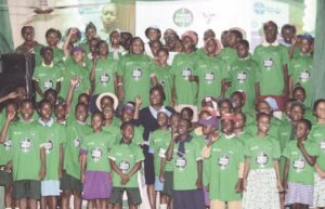 Abikoye (middle) surrounded by school pupils at the event