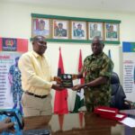 Commander 2 Brigade Nigeria Army Alexander Tawasimi presenting a souvenir to chairman of Correspondents’ Chapel of NUJ , Akwa Ibom state council Comrade Bassey Anthony during courtesy visit recently