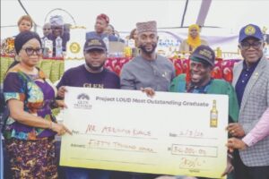 One of the beneficiaries receiving his award from organisers of the programme