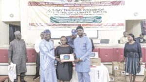 UBEC officials presenting tablet to one of the teachers