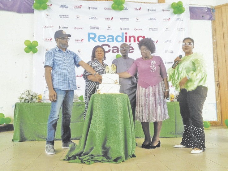 L-R- Familoni, Mrs Eke, Nurayn and others cutting the anniversary cake