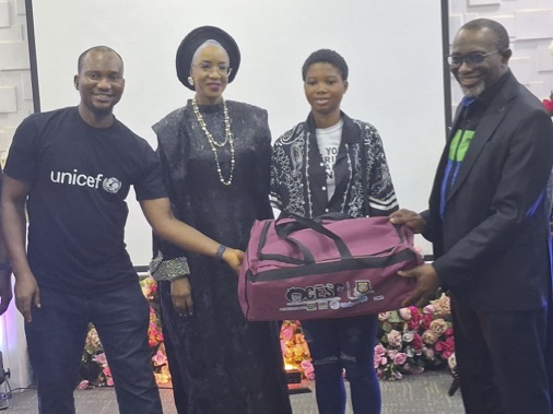 Okorie (left) and Dr. Abdul presenting a toolkit to a benefiaciary