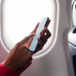 Passenger with phone on an airplane