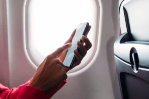 Passenger with phone on an airplane