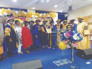 Prof. Ugah receiving his certicate, while others watch