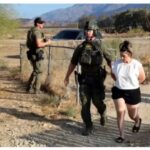 Rebecca Haro being led away by police after her arrest last Friday