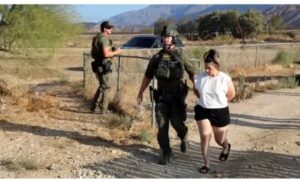 Rebecca Haro being led away by police after her arrest last Friday