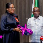 Hon Justice Florence Duroha-Igwe (retd) presenting sealed report to Abia Governor Alex Otti