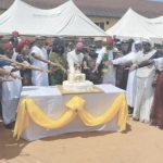 Celebrant, Archbishop Okeke cutting cake with other