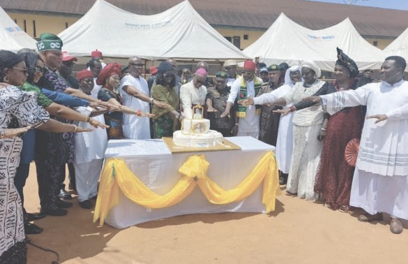 Celebrant, Archbishop Okeke cutting cake with other
