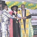 Dr. Abdul presenting plaque of discharged to Dr. Olaseni with his wife, Pastor Olaseni