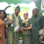 Elijah Otumu celebrating his award with family members.