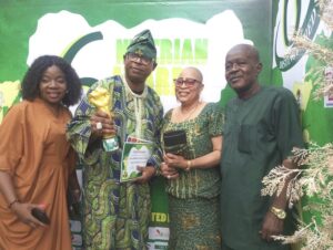 Elijah Otumu celebrating his award with family members.