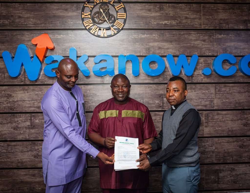 Group Chief Executive Officer of Wakanow.com, Bayo ‘Lion’ Adedeji flanked by Fr. Cyriacus Emedolu, Madonna University Administrator (right) and Mr. Chima Achu, alumnus of Madonna University, during the official presentation of the letter nominating him for the conferment of an Honorary Doctor of Business Administration by the institution.