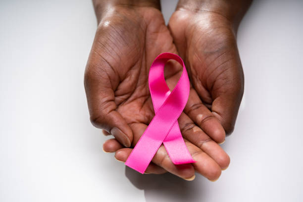 Human Hand Showing Pink Ribbon To Support Breast Cancer Cause