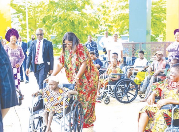 •Mrs Nwifuru distributes wheelchairs