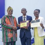 Prof. Ademola (middle) receives handshake and award from Prof. Falola (left) and VC’s wife, Prof. Grace Tayo at the lecture