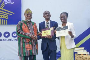 Prof. Ademola (middle) receives handshake and award from Prof. Falola (left) and VC’s wife, Prof. Grace Tayo at the lecture