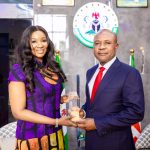 Chioma Ude, Founder/CEO of the Africa Foundation, presents award to Enugu Governor Peter Mbah