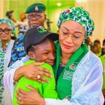 First Lady, Oluremi Tinubu in a warm embrace with Esther Abraham, a poet and Senior Secondary 3 student from Government Senior Secondary School, Mabushi