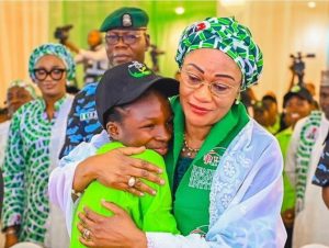 First Lady, Oluremi Tinubu in a warm embrace with Esther Abraham, a poet and Senior Secondary 3 student from Government Senior Secondary School, Mabushi
