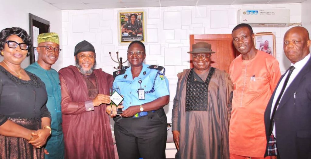 Mr. Joe Femi-Dagunro, Founder/President, Kosofe Chamber of Commerce & Industry  Presenting a complimentary crystal to the NPF Area Commander, Area H, Ogudu, ACP Sholla Omilade and other members of Chamber from left, Dr. Mrs. Dideolu Adekogbe, Arc. Femi Fabuyi, Prince Enajemo-Isire, Mr. Joel Omole, Mr. John Ologe