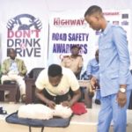 A Red Cross official simulates resuscitation of an accident victim at the scene of a road crash