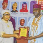 George Oshiokhamele Junior receiving the post – humous award on behalf of his late father