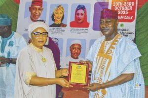 George Oshiokhamele Junior receiving the post – humous award on behalf of his late father
