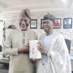 Mohammed (right) presenting a copy of the book to Abdul