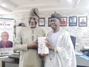 Mohammed (right) presenting a copy of the book to Abdul