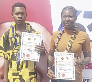 Numa and Joseph displaying their certificates.