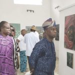 Oladipo and guests looking at some of the artworks