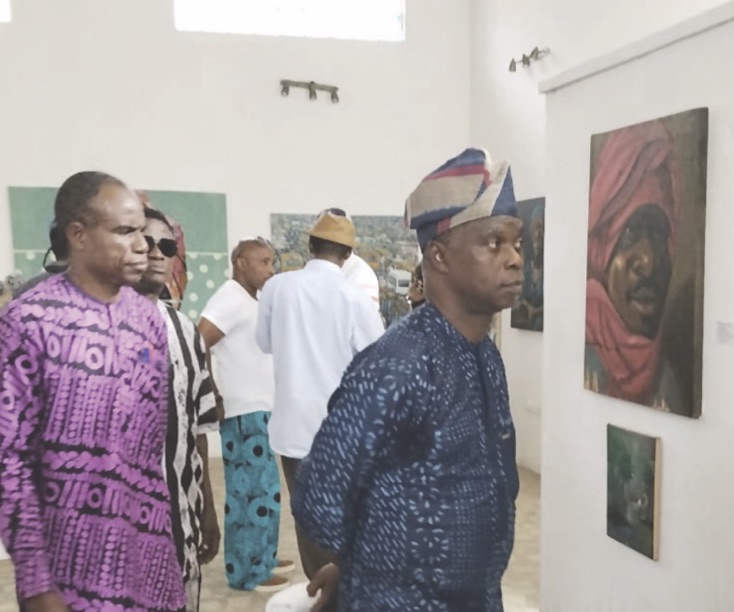 Oladipo and guests looking at some of the artworks
