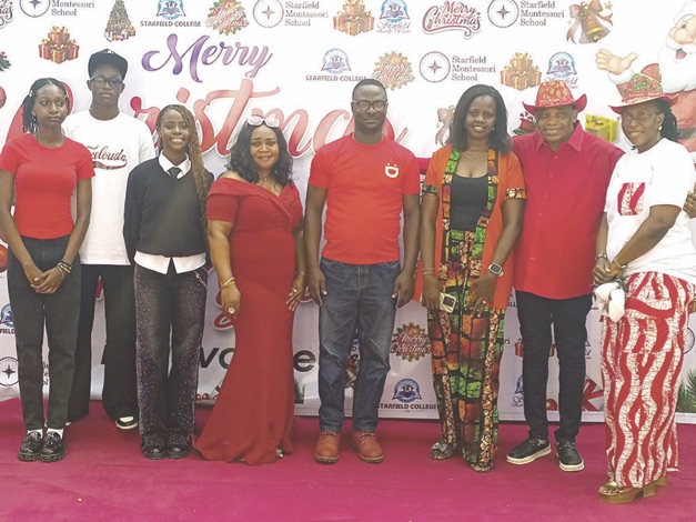 Sara (right), Eigbe (2nd right), students and parents at Xmas party