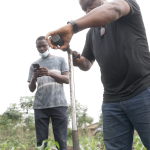 A team of Nigerian scientists led by Dr. Gilbert Adie at the University of Ibadan sampled soil and dust near battery recycling factories in Ogijo. (Image from video by Taylor Turner and Grace Ekpu for The Examination)