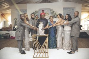 The celebrant, Sir Emeka Ukwuaba (middle), flanked by family members, cutting the birthday cake