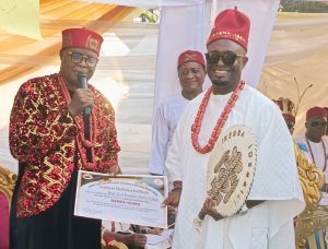 Chairman of Idemili North and South Traditional Rulers Forum, Igwe Charles Agbala handing over Certificate of Recognition to Chief Hamilton Emeka Ezeonu after his recognition as Ikemba Idemili yesterday in Abatete, Anambra State